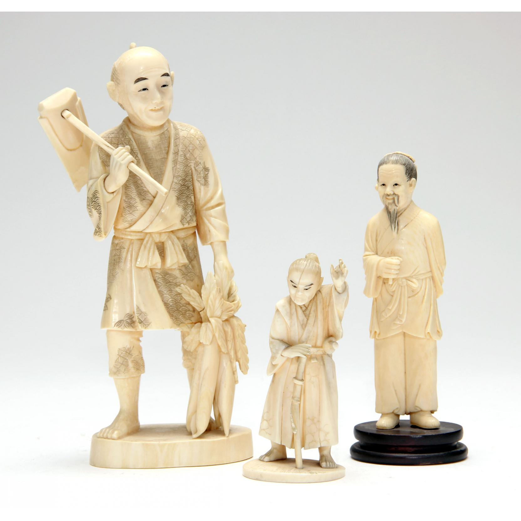 Appraisal: Three Japanese Ivory Okimonos the first a farmer carrying a