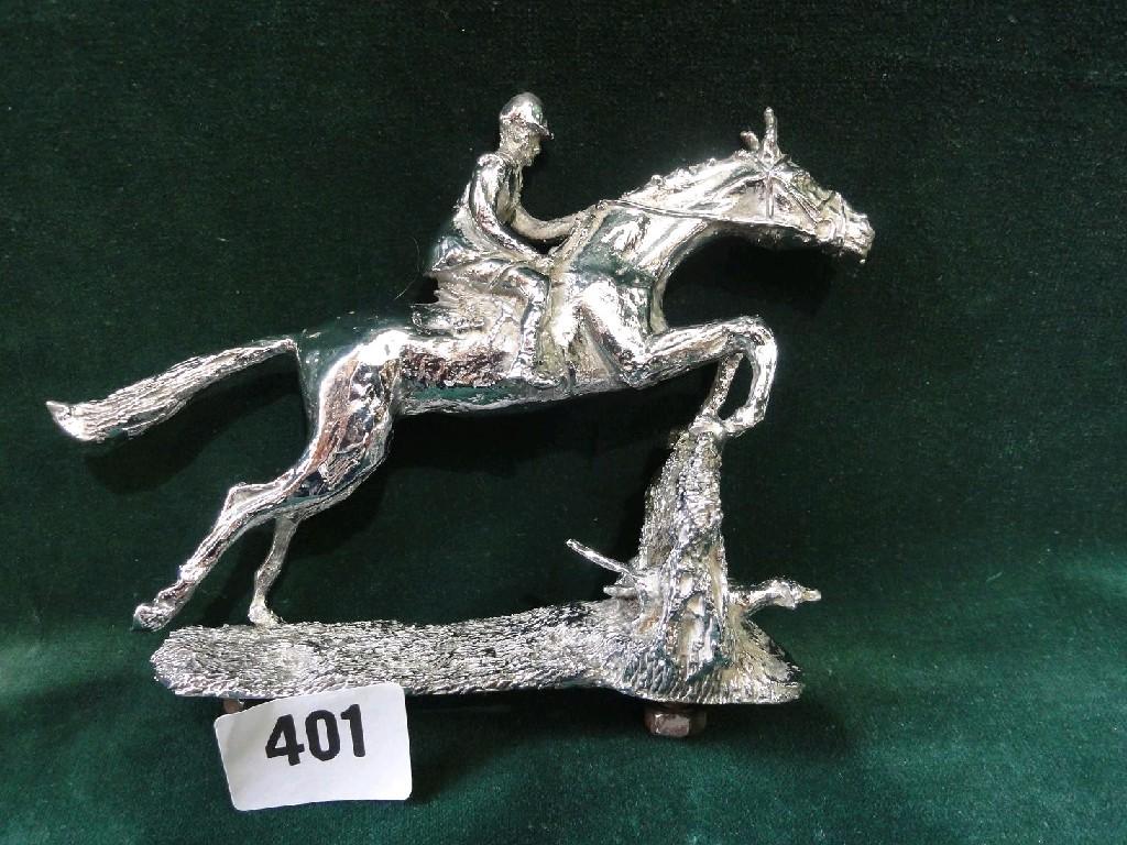 Appraisal: A chromium plated model of a huntsman jumping a fence