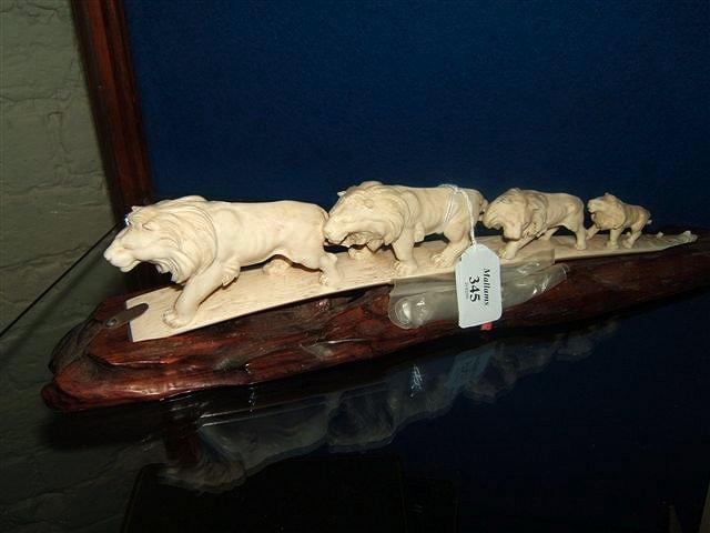 Appraisal: An old carved ivory group of five graduated lions following