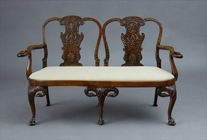 Appraisal: GEORGE II-STYLE CARVED WALNUT SETTEE The arched crest above carved