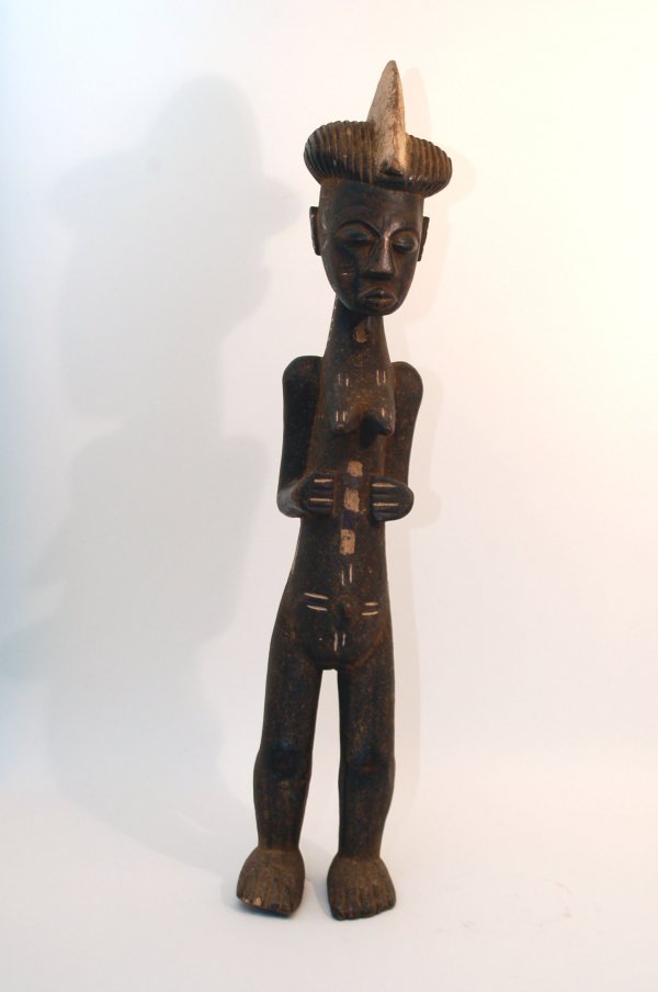 Appraisal: A large Senufo female figure with dark encrusted patina with