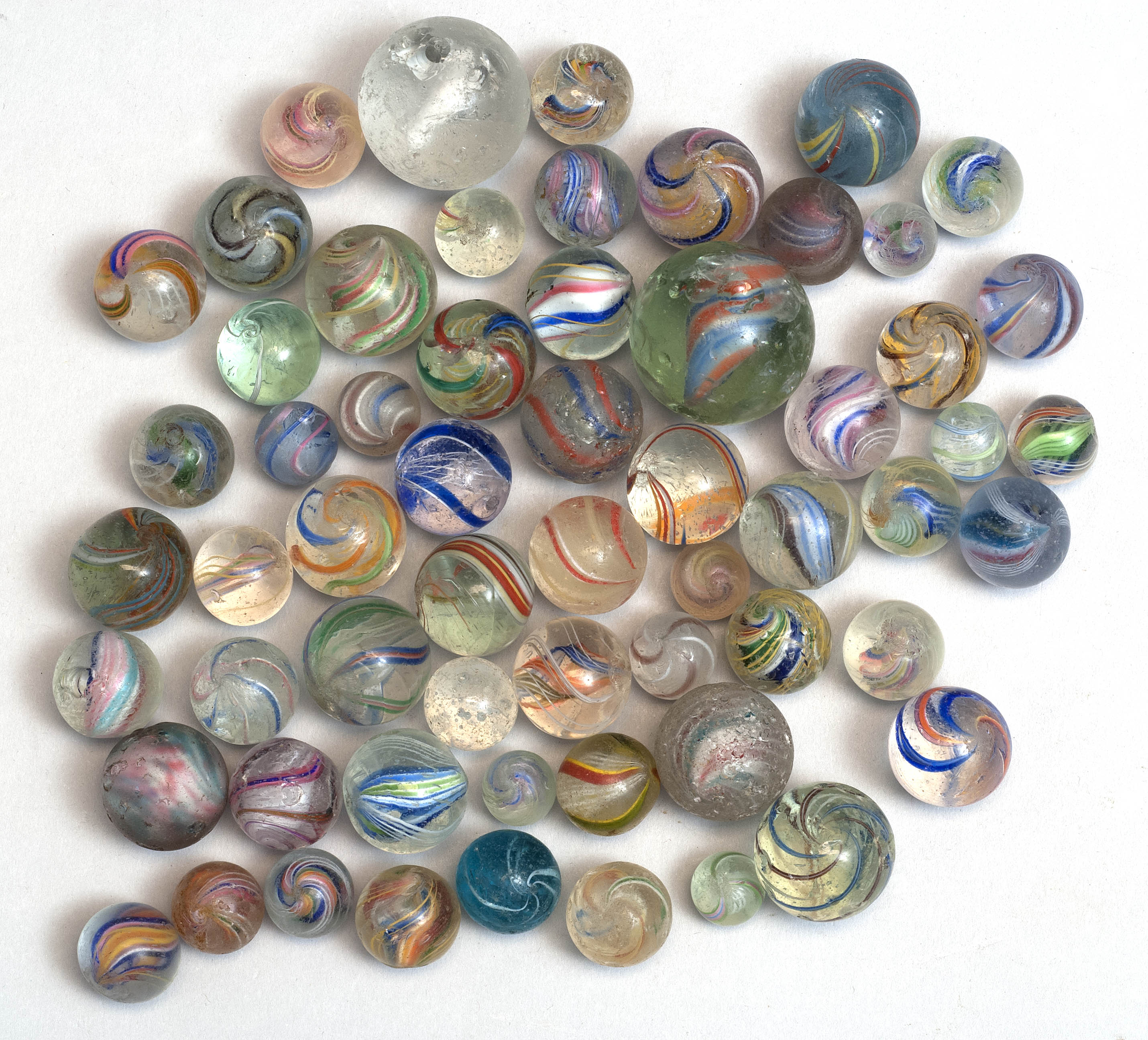 Appraisal: SIXTY ASSORTED GLASS MARBLES Mostly swirl glass One sulfide ConditionUsed