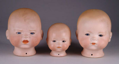 Appraisal: THREE BISQUE DREAM BABY HEADS Smallest marked AM the two