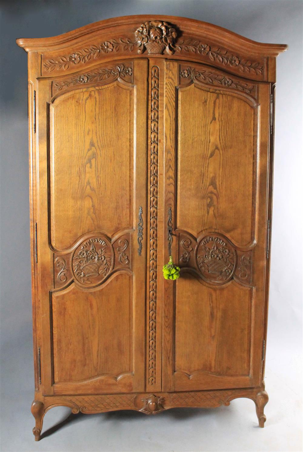 Appraisal: LOUIS XV STYLE OAK ARMOIRE curved pediment with floral basket