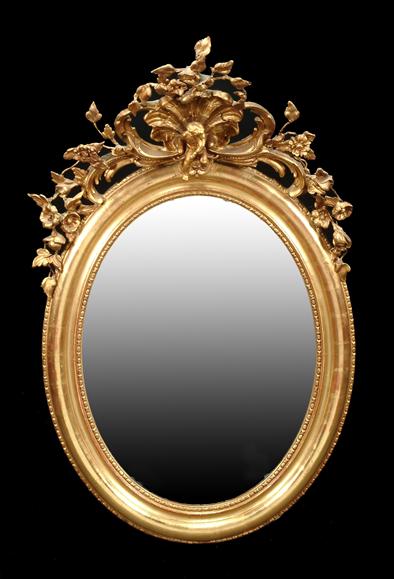 Appraisal: A Continental oval giltwood wall mirror and composition in th