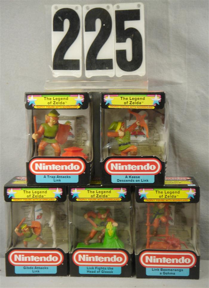 Appraisal: Lot of Nintendo Trophy Figures with Scorecards all mint in