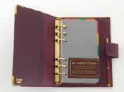 Appraisal: A 'must de Cartier' red leather bound organiser with inserts