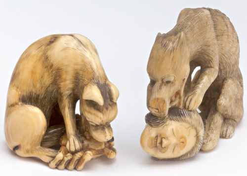 Appraisal: JAPANESE NETSUKE Two carved and stained ivory figures of wolves