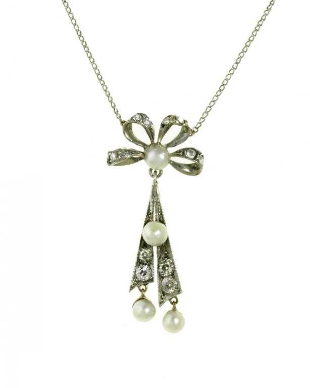 Appraisal: A DIAMOND AND CULTURED PEARL PENDANT of double dart form