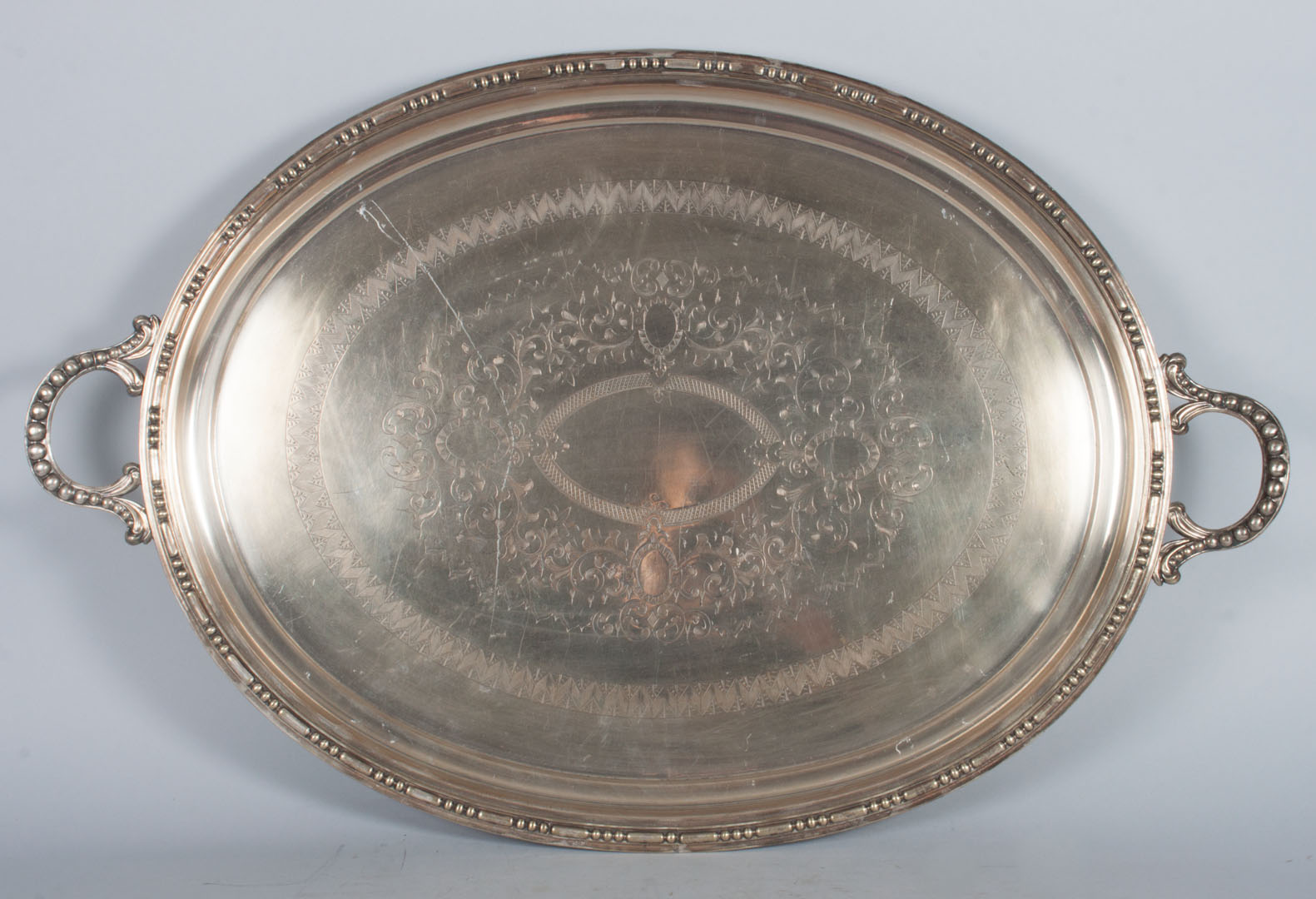 Appraisal: Engraved silver-plated oval tea tray scroll feet x in