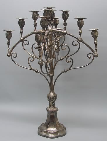 Appraisal: Two arched tubular supports at right angles supporting candle sockets