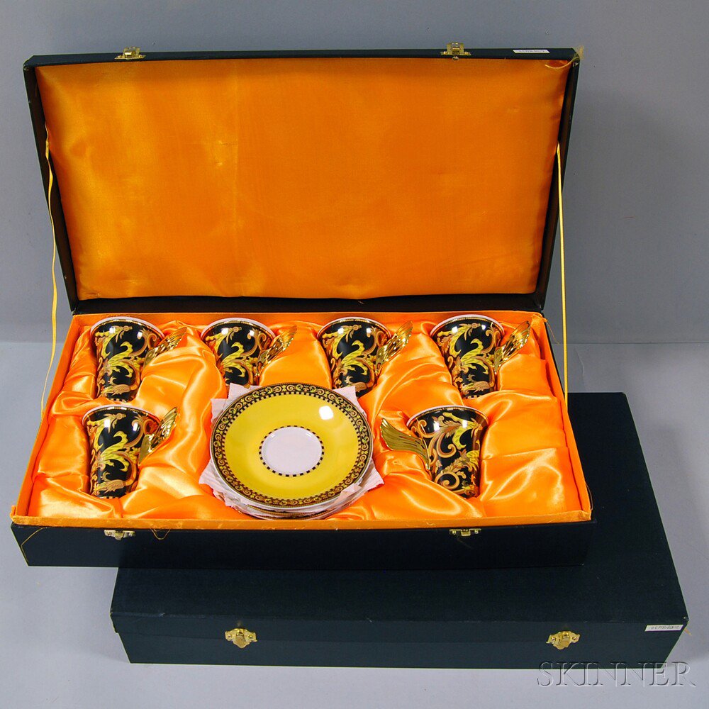 Appraisal: Two Cased Sets of Barocco Teacups and Saucers After Versace