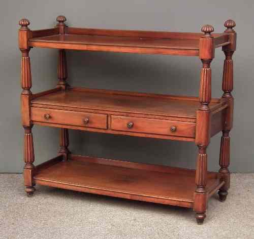 Appraisal: A Victorian mahogany three tier tray top dinner wagon on