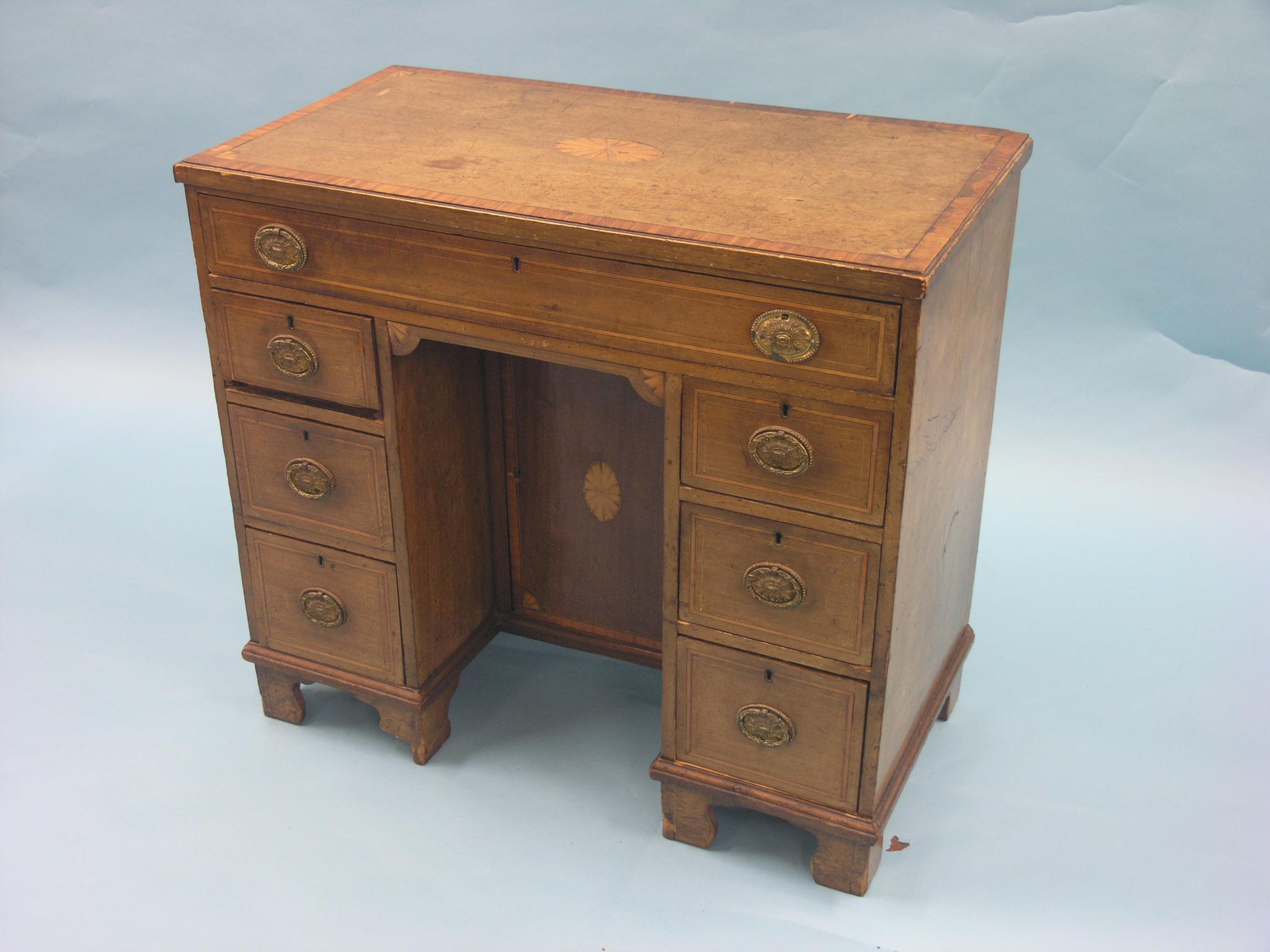 Appraisal: A George III inlaid mahogany kneehole desk arrangement of seven