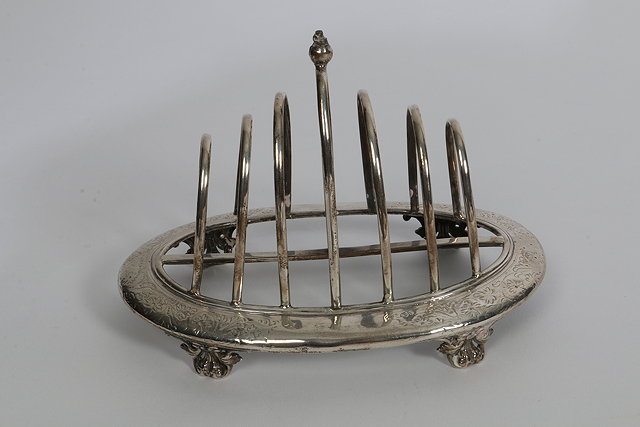 Appraisal: A VICTORIAN SILVER SIX DIVISION TOAST RACK oval shaped base