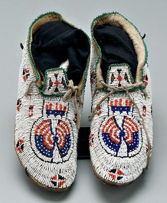 Appraisal: Pair beaded moccasins sinew sewn red blue and green designs