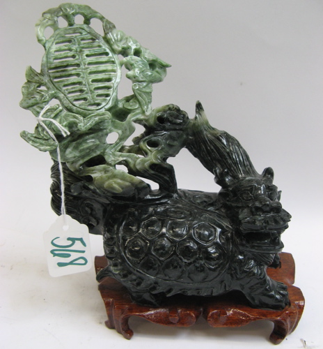 Appraisal: A CHINESE CARVED JADE FIGURE apple green shading to spinach