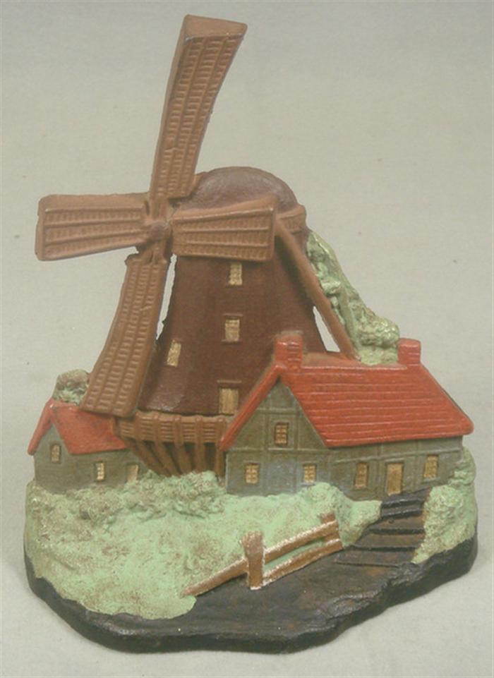 Appraisal: Cast iron doorstop large windmill and house on grassy base