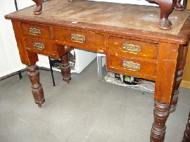 Appraisal: A Victorian writing desk in oak with central drawer flan