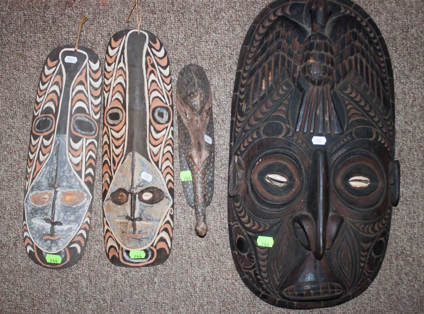 Appraisal: Four mask plaques New Guinea th century carved and painted