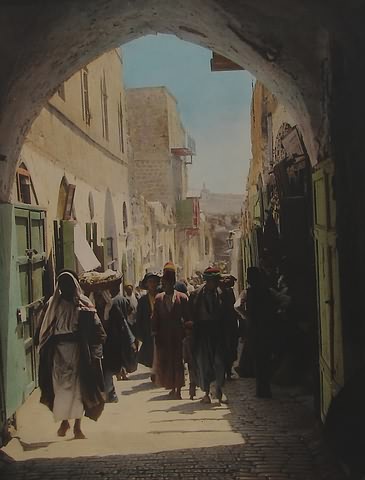 Appraisal: Early th century hand-colored photograph showing street scene with many