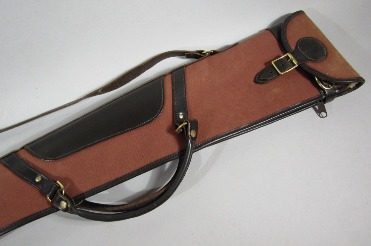 Appraisal: A canvas and leather shoulder gun case