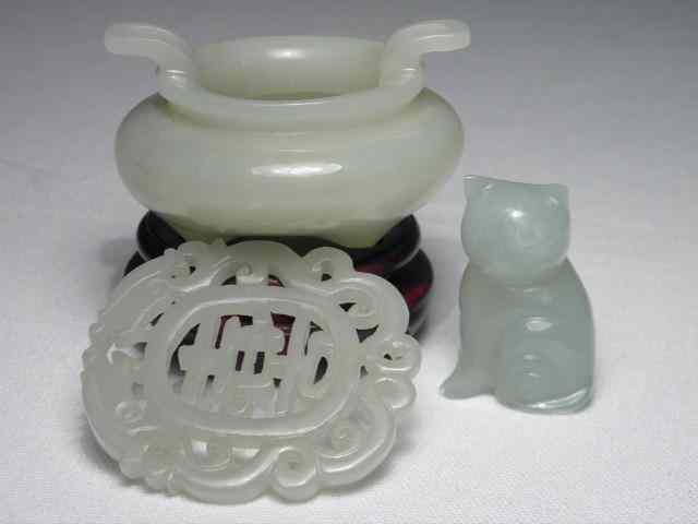 Appraisal: Chinese carved jade items Includes a two-handled carved green jade