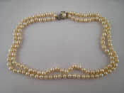 Appraisal: A two row cultured pearl necklace with a white metal