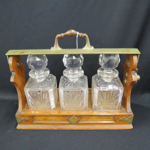 Appraisal: English Tantilus Set a trio of cut crystal decanters in