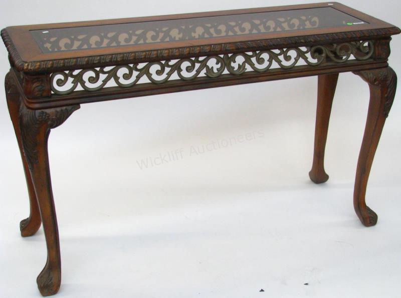 Appraisal: A decorator-quality entry console wood and cast metal table neoclassical