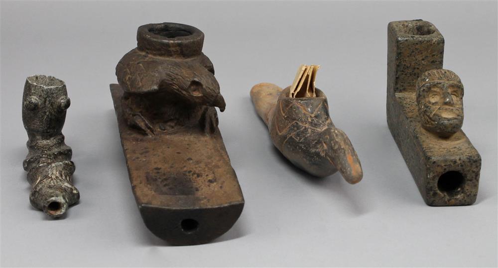 Appraisal: FOUR EFFIGY PIPES th C reproductions one stone platform pipe