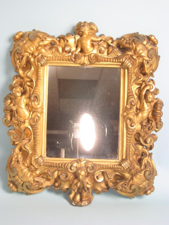 Appraisal: An th Century carved giltwood Mirror with cherubs dragon masks