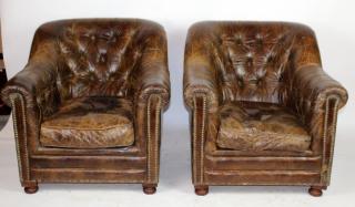 Appraisal: Pair of tufted leather armchairs A pair of distressed tufted