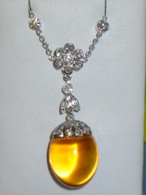 Appraisal: A CITRINE AND DIAMOND PENDANT the ovoid cabochon citrine in