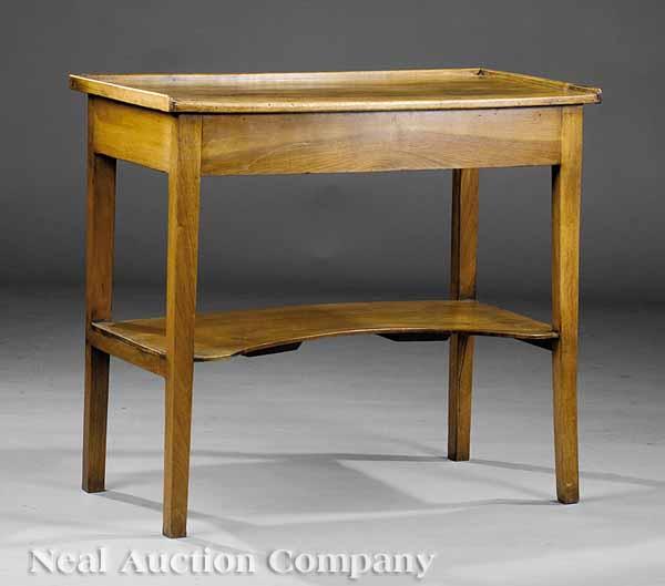 Appraisal: A French Restauration Walnut Two-Tiered Table th c galleried top