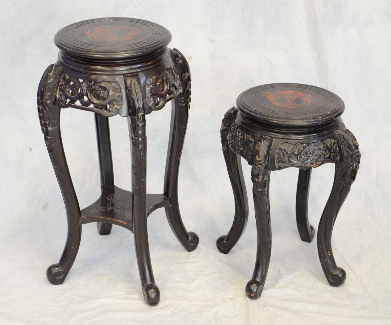 Appraisal: Asian black lacquer and carved taborettes with painted dragons on