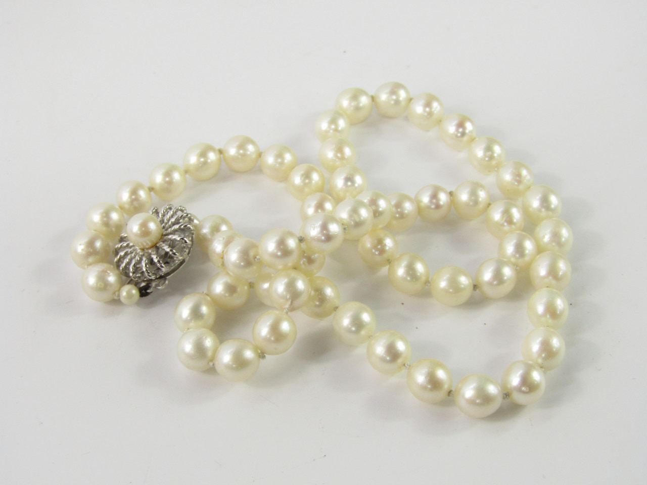 Appraisal: A string of cultured pearls on a silver and cultured