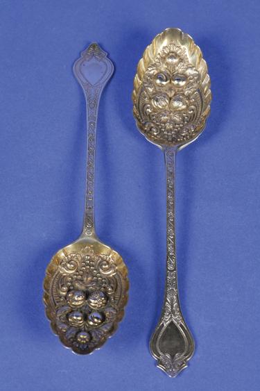 Appraisal: A PAIR OF LATE VICTORIAN BERRY SPOONS with engraved stems