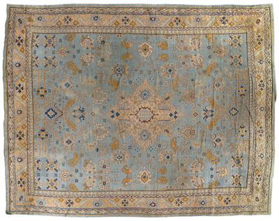 Appraisal: Large Oushak rug repeating geometric and stylized floral designs on