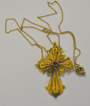 Appraisal: Yellow metal filigree cross set with small red stone stamped