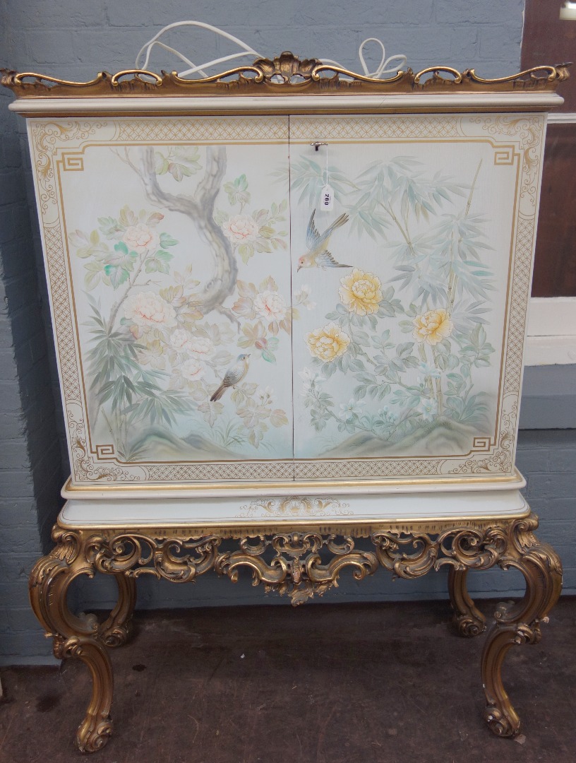 Appraisal: A painted decorated and carved giltwood cocktail cabinet th century