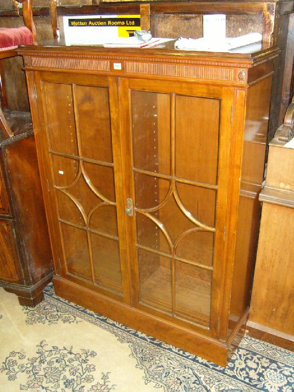 Appraisal: An Edwardian walnut display cabinet enclosed by glazed panelled doors