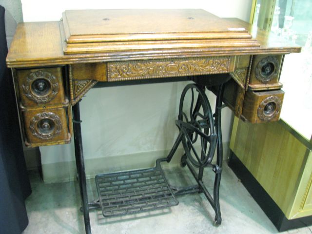 Appraisal: Oak treadle sewing machine cabinet four drawers carved case sewing