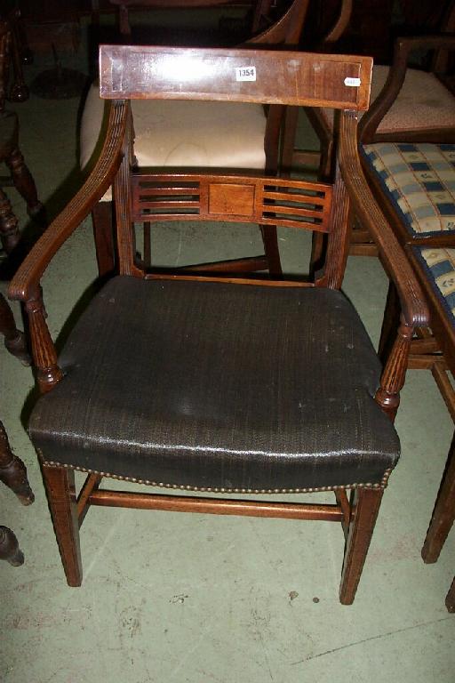 Appraisal: A Georgian mahogany armchair with rail back fluted arms and