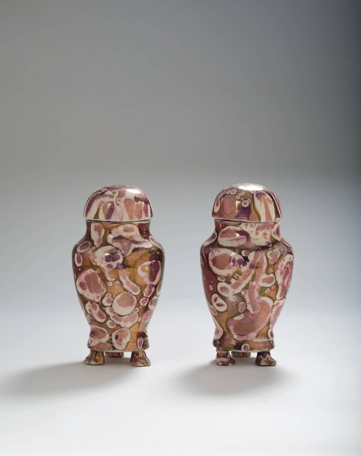 Appraisal: PAIR OF BRITISH MOTTLED PURPLE-PINK LUSTRE JARS AND COVERS CIRCA