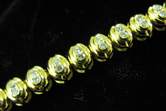 Appraisal: DIAMOND AND FOURTEEN KARAT GOLD BRACELET The chain bracelet has