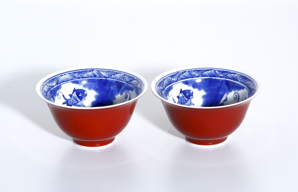 Appraisal: Pair of Blue and White and Oxblood Glazed Cups Mid-Qing