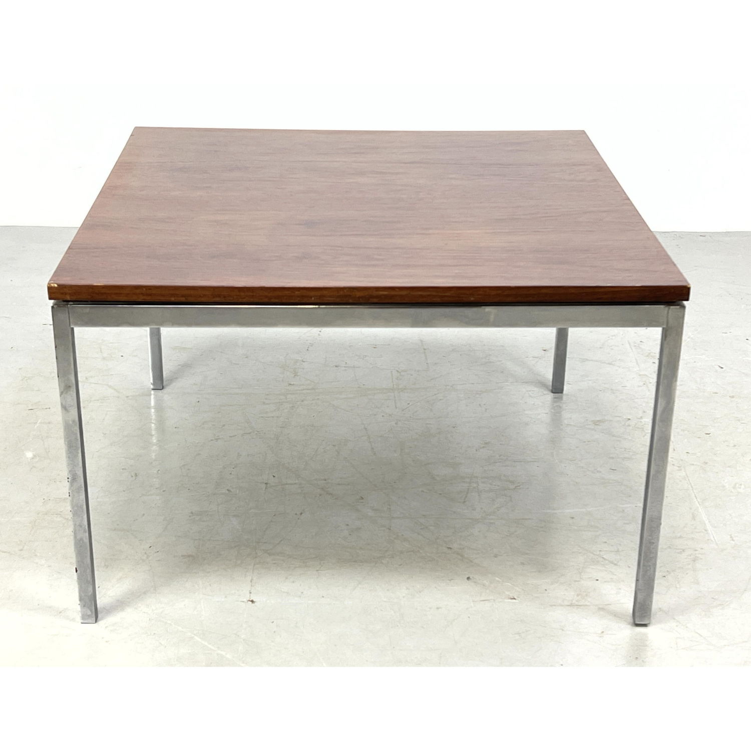 Appraisal: Florence KNOLL rosewood and chrome table Labeled Dimensions H inches