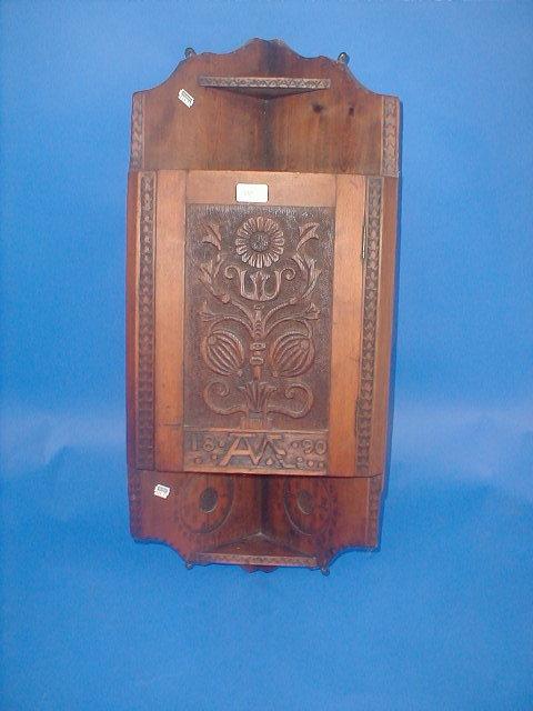 Appraisal: A late Victorian carved pine hanging corner cupboard