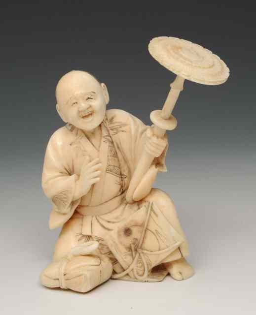 Appraisal: A JAPANESE CARVED IVORY OKIMONO in the form of a